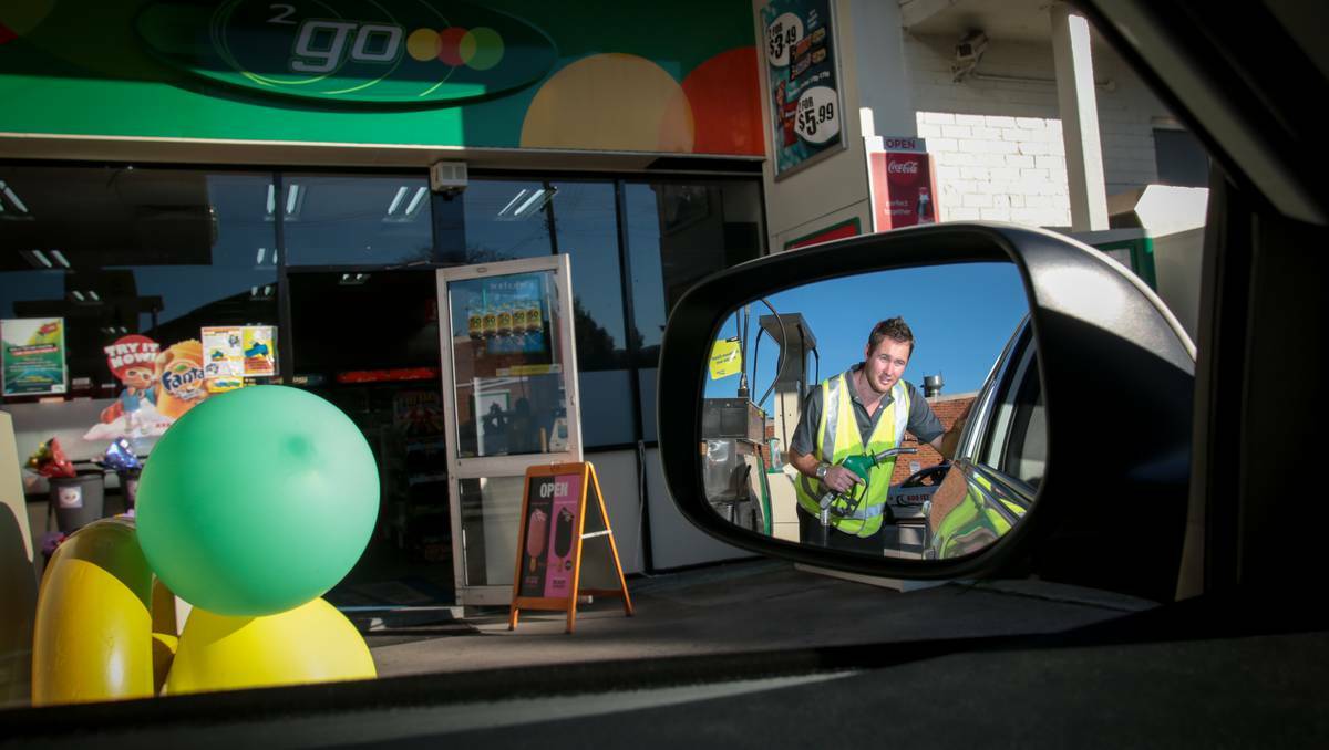 Guy Higgins at the pump of the BP service station at the top of Crown Street, Wollongong, which is offering old-style driveway service. Photo: ADAM McLEAN